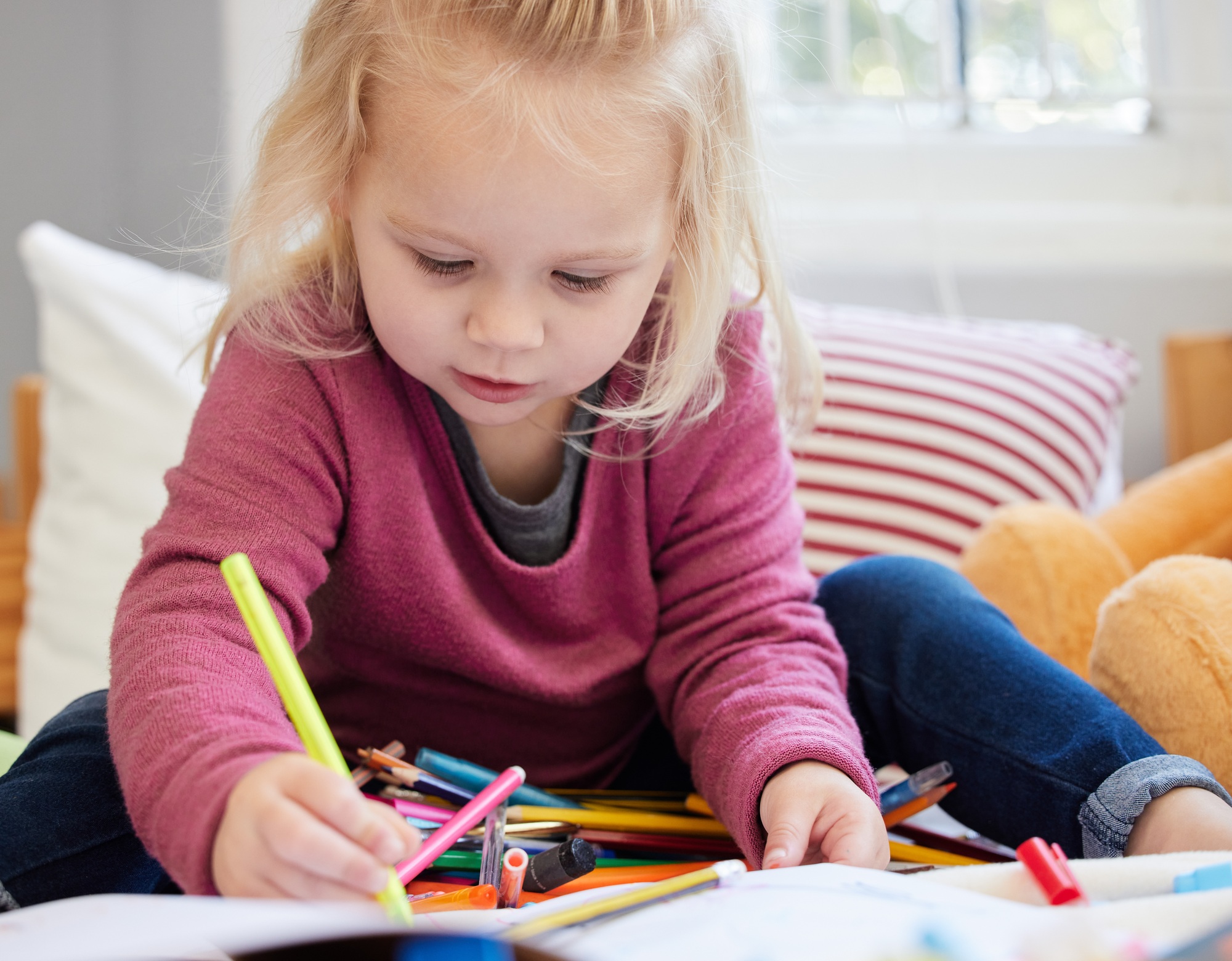 An artist in the making. Shot of a little girl drawing at home.