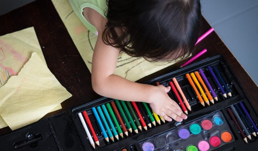 little girl choosing colours for drawing time.