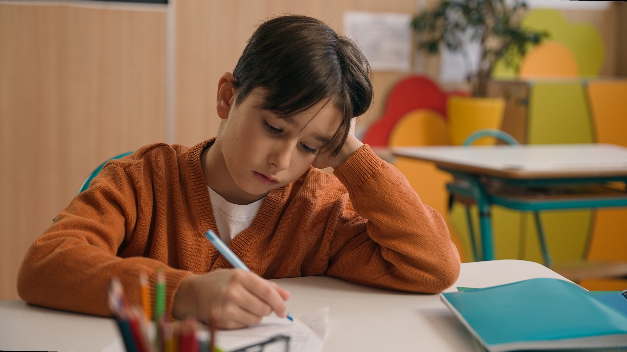 Little school boy primary schoolboy Caucasian son kid child clever smart writing task exercise at