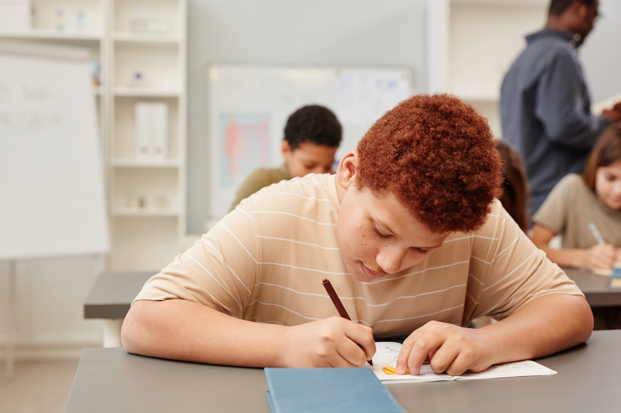 Red Haired Boy Studying in School