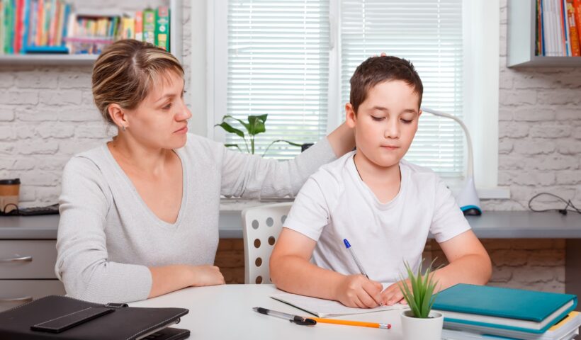 The tutor is engaged with the child, teaches to write and count