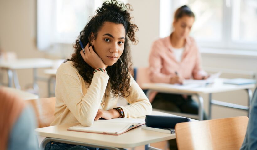 African American high school student in the classroom looking at camera.
