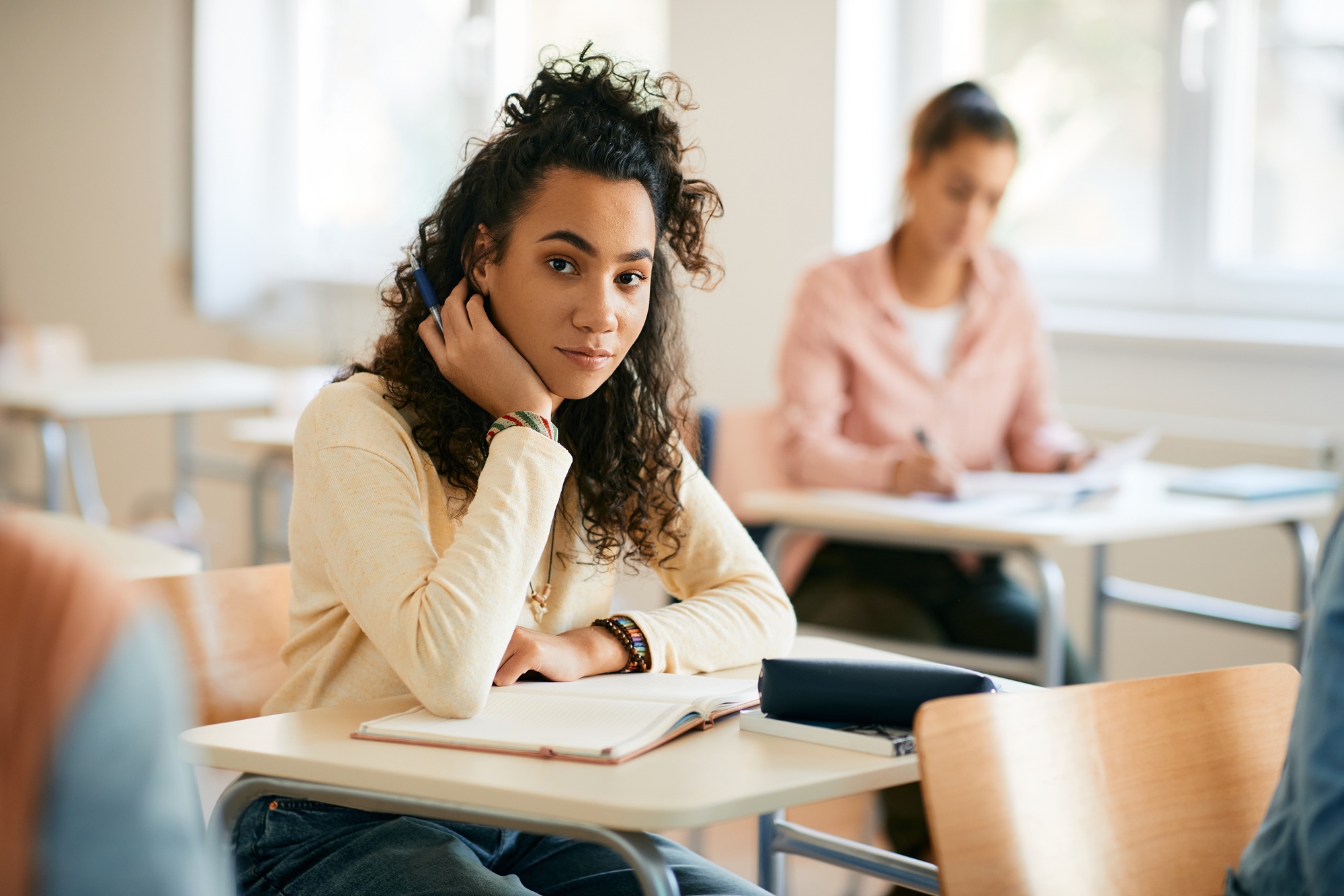 African American high school student in the classroom looking at camera.