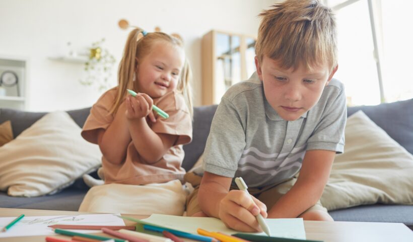 Brother and Sister Drawing Together at Home