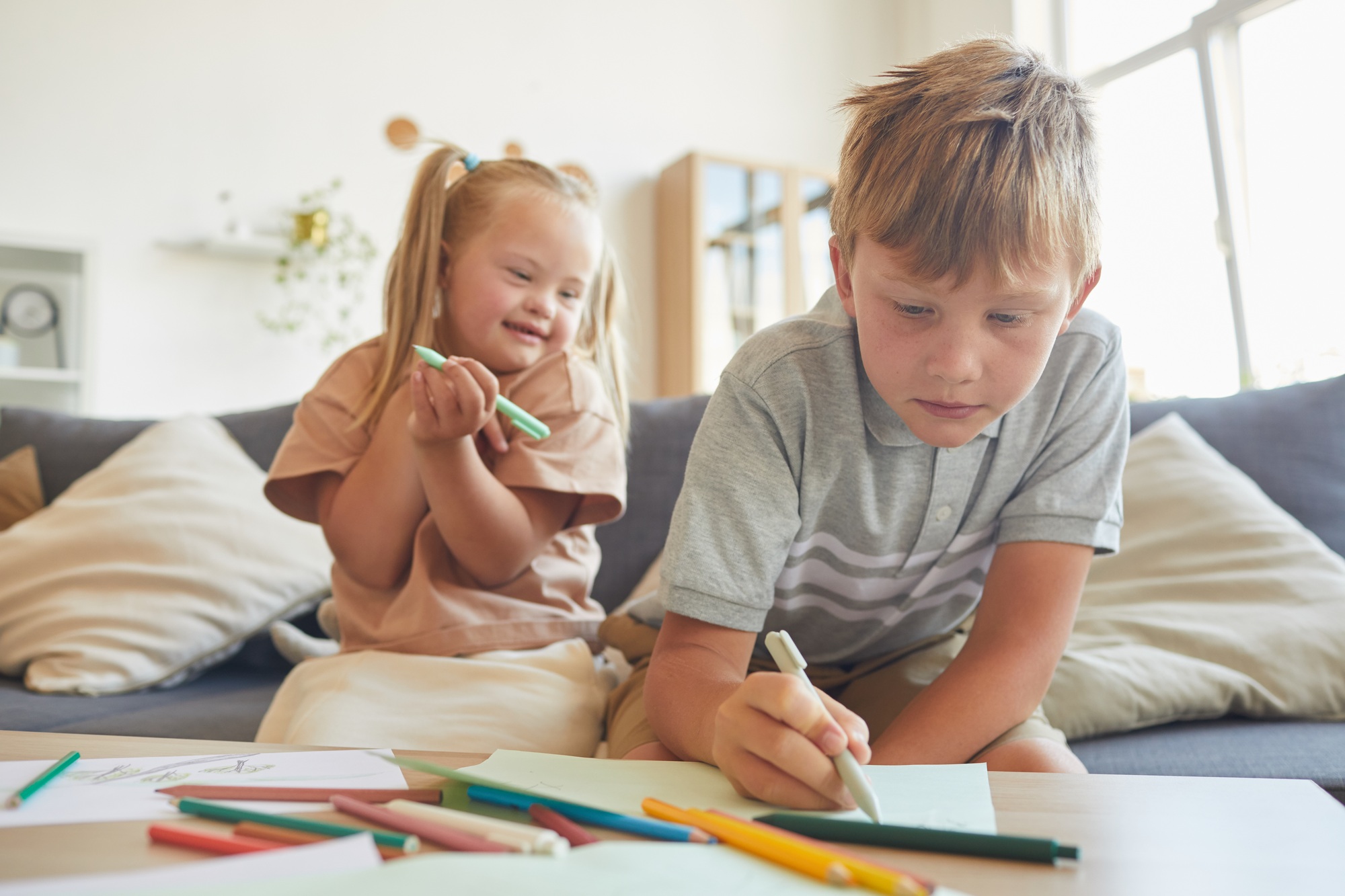 Brother and Sister Drawing Together at Home