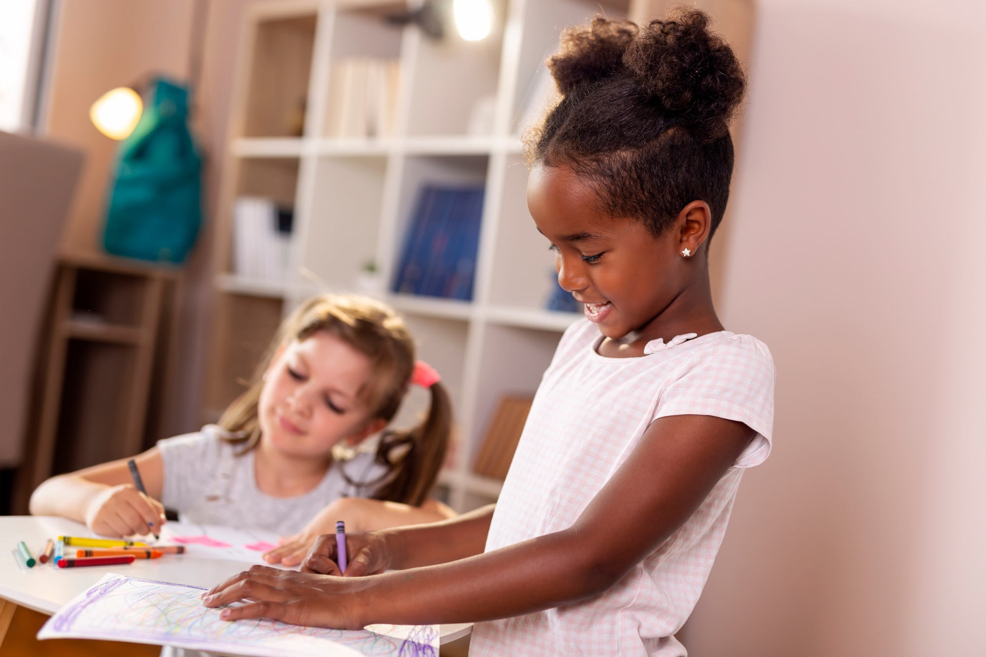 Girls drawing with crayons