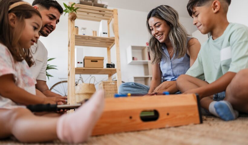 Close-up of a Latin American family enjoying a foosball game