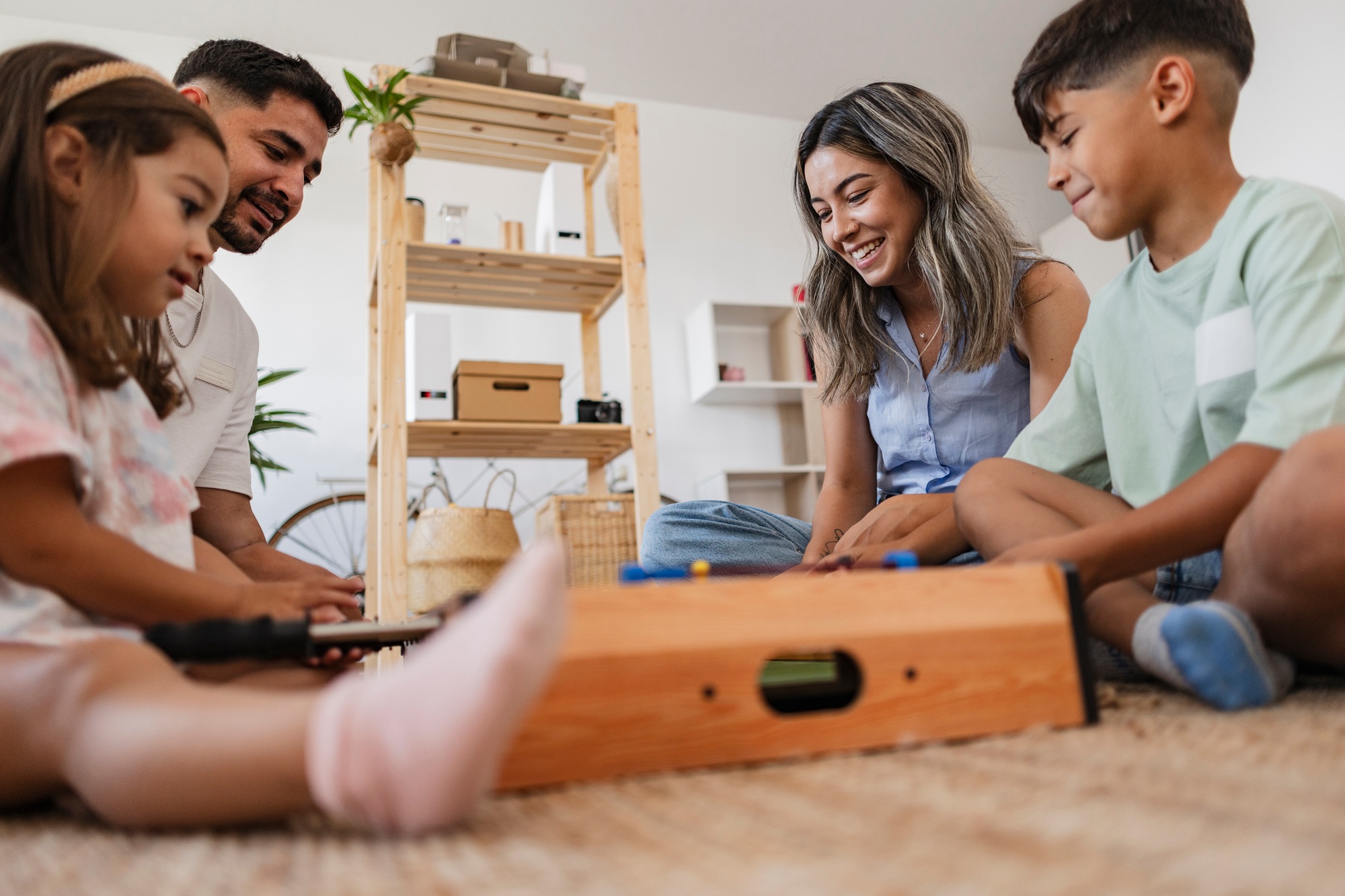 Close-up of a Latin American family enjoying a foosball game