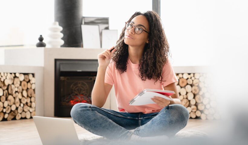 Dreamy thoughtful pensive young woman author student doing paperwork, writing poetry novels