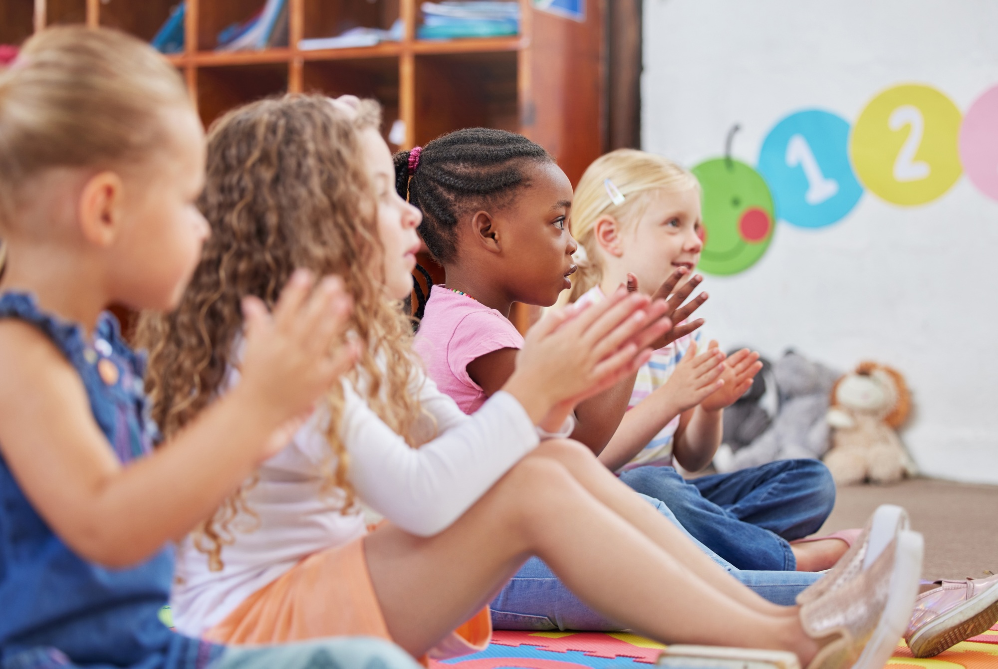 Learning made fun. Shot of children clapping hands while sitting in class.