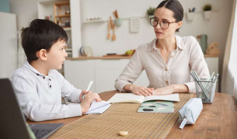 Mother Helping Son Doing Homework