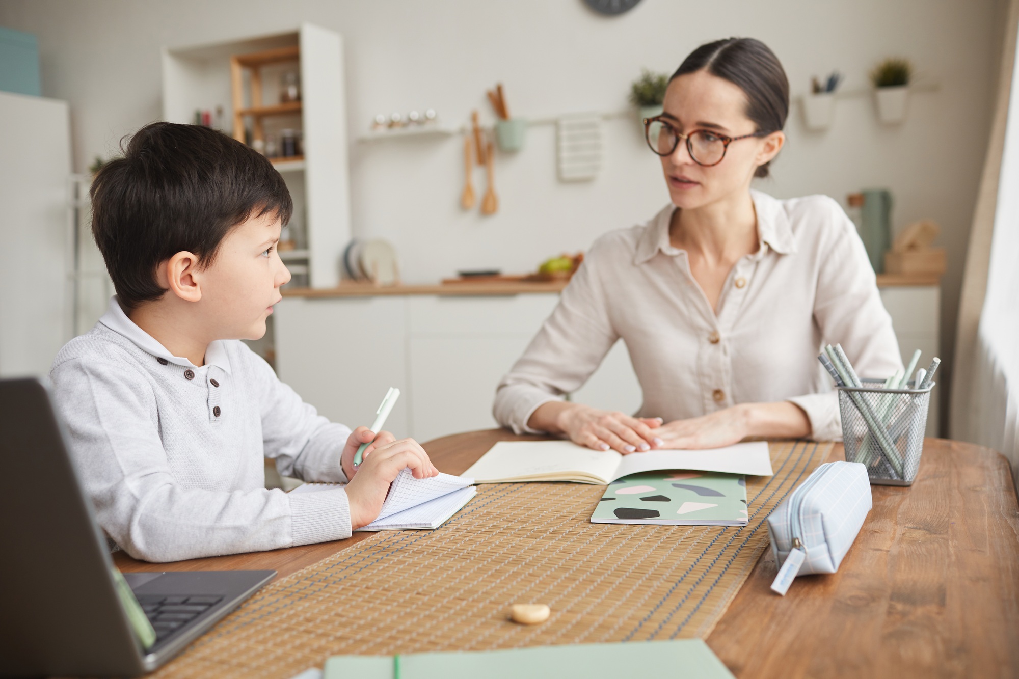 Mother Helping Son Doing Homework