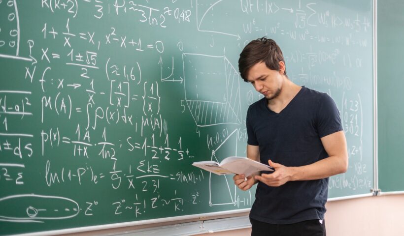 pupil doing homework on blackboard b
